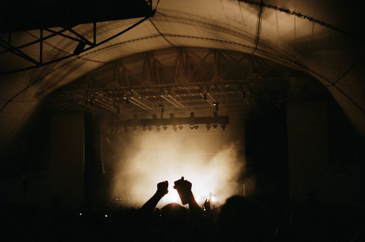 Silhouettes against pale stage smoke